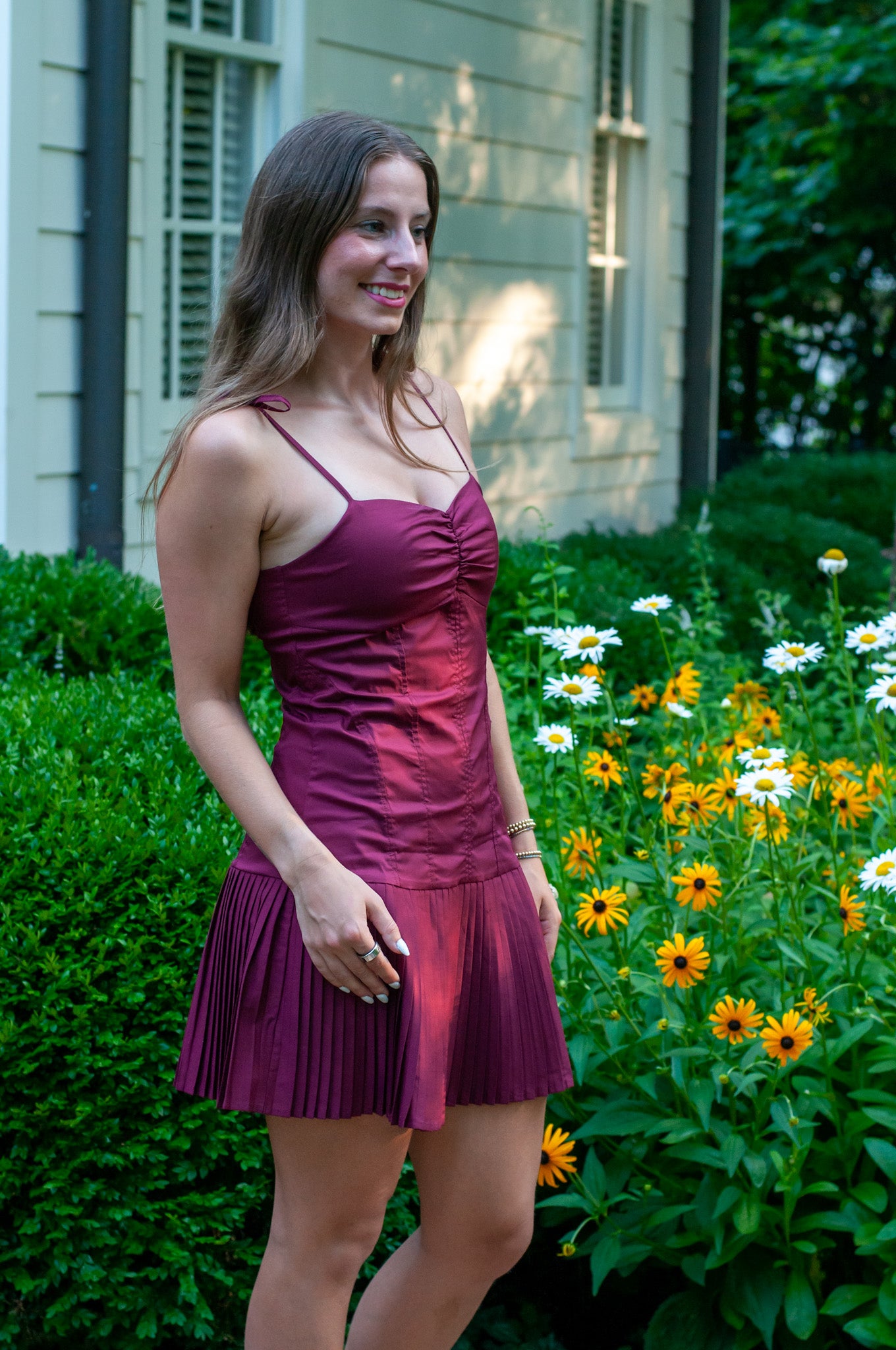 Burgundy cotton mini dress with mini pleat skirt, drop waist, sweatheart neckline that gather in the center and cami straps.