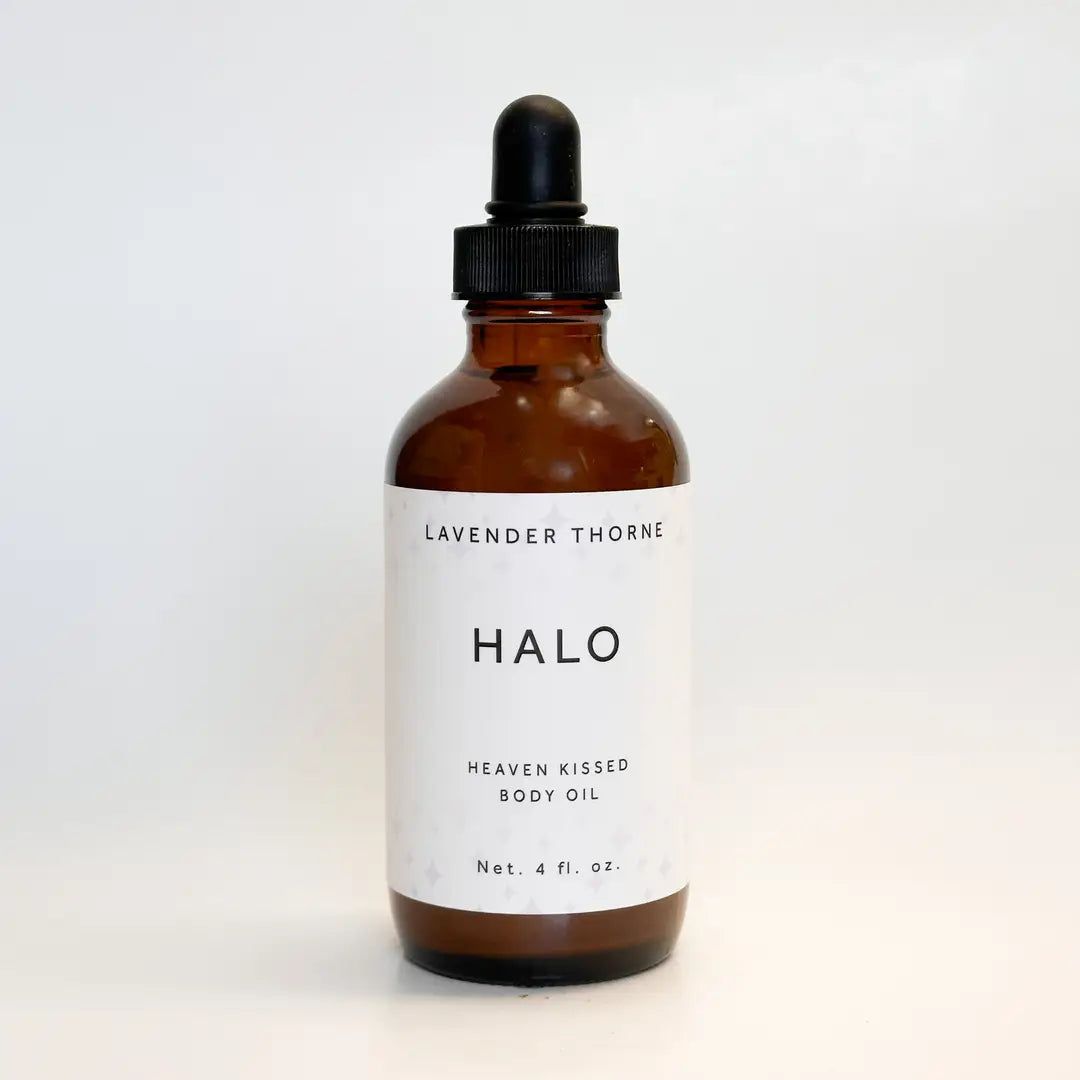 An amber glass dropper bottle of Halo Lavender Thorne Heaven Kissed Body Oil on a clean white background.