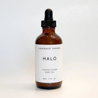 An amber glass dropper bottle of Halo Lavender Thorne Heaven Kissed Body Oil on a clean white background.