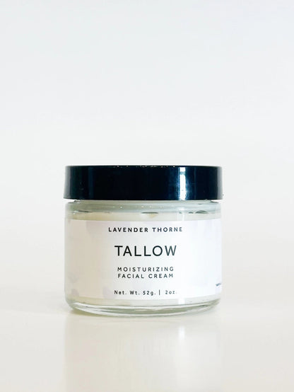 A clear glass jar of Tallow Lavender Thorne moisturizing facial cream with a black lid and white label, set against a clean white background.